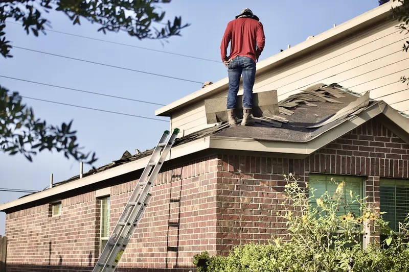 Professional roofer working on a residential roof in Bearcreek